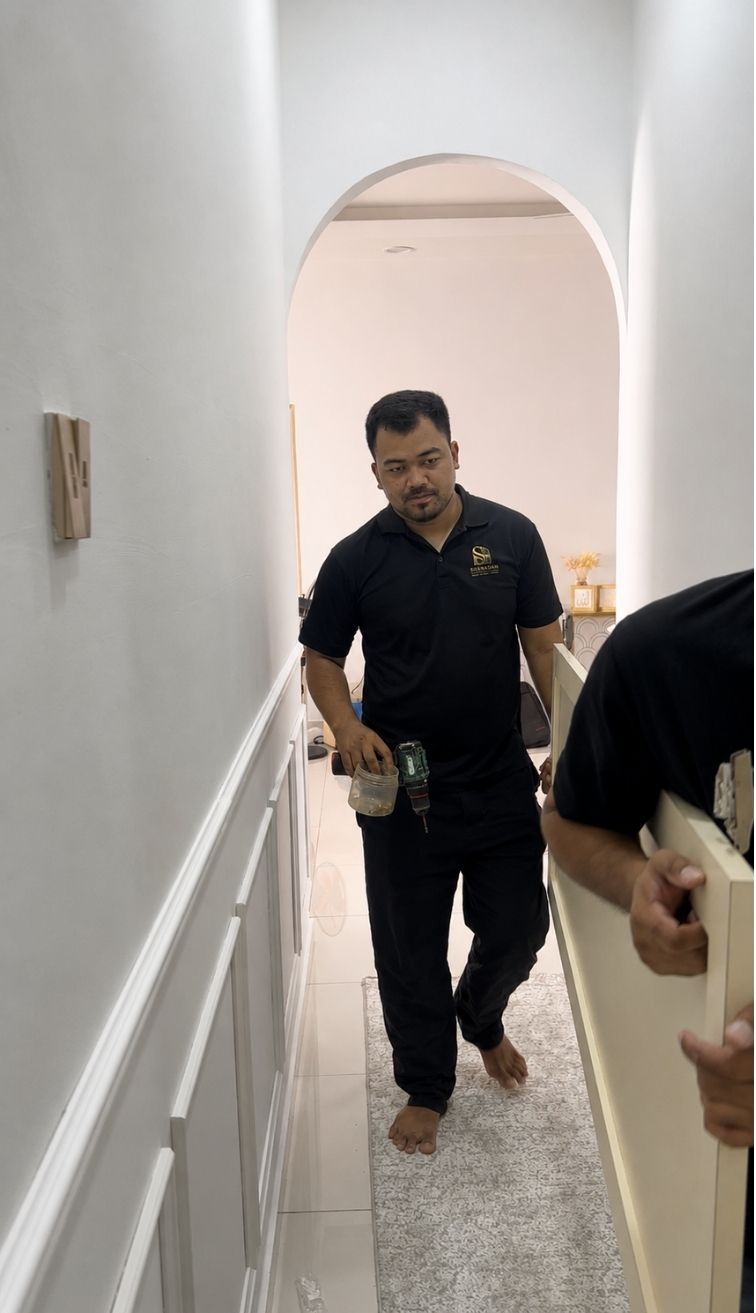 A Shahadah Studio installer fitting custom cabinetry on site
