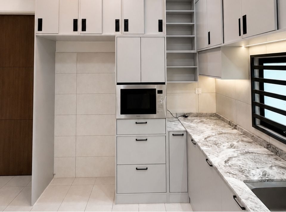 Tall cabinet tower housing the built-in microwave and pull-out drawers, finished with marble-look countertop and continuous soft-glow LED lighting