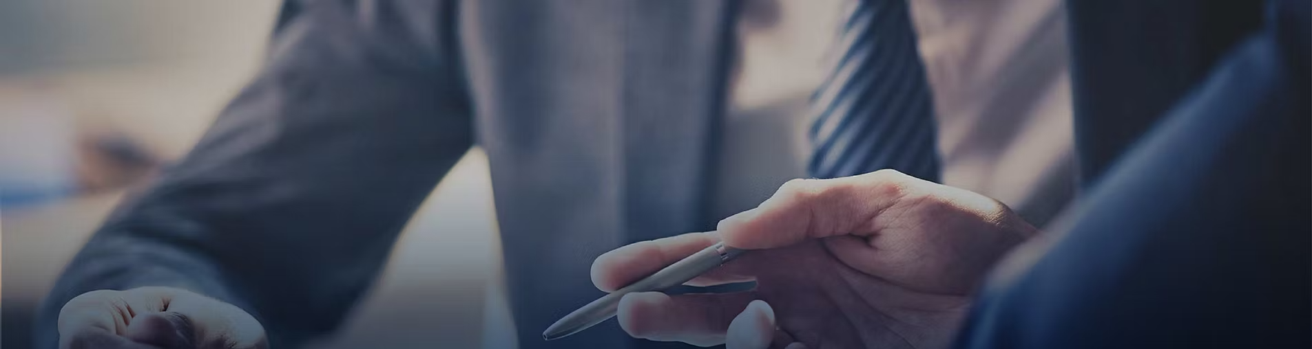 Business professional reviewing documents and signing